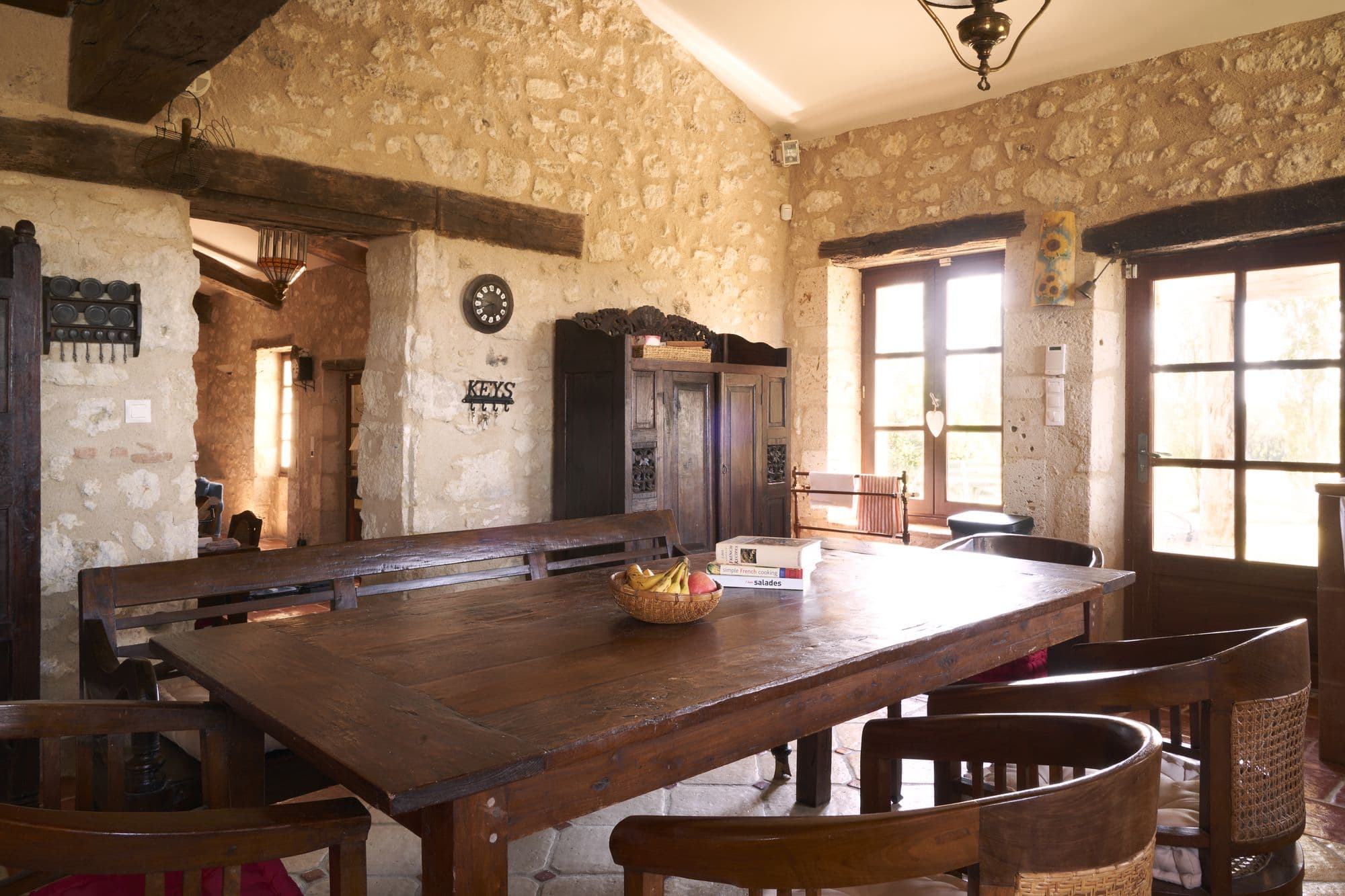 A long refectory table in the stone-walled room off the kitchen
