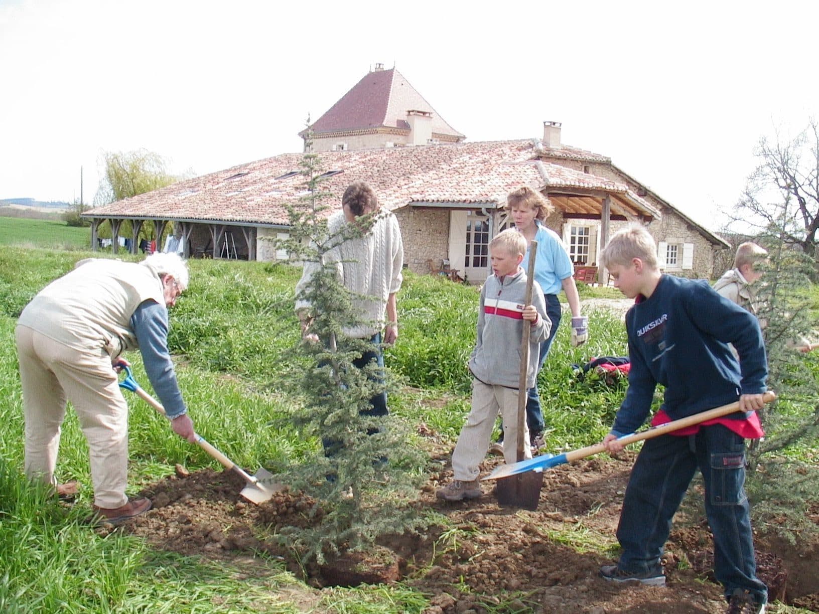 Three generations of the family planting a tree in front of the house during the renovation, Easter 2004