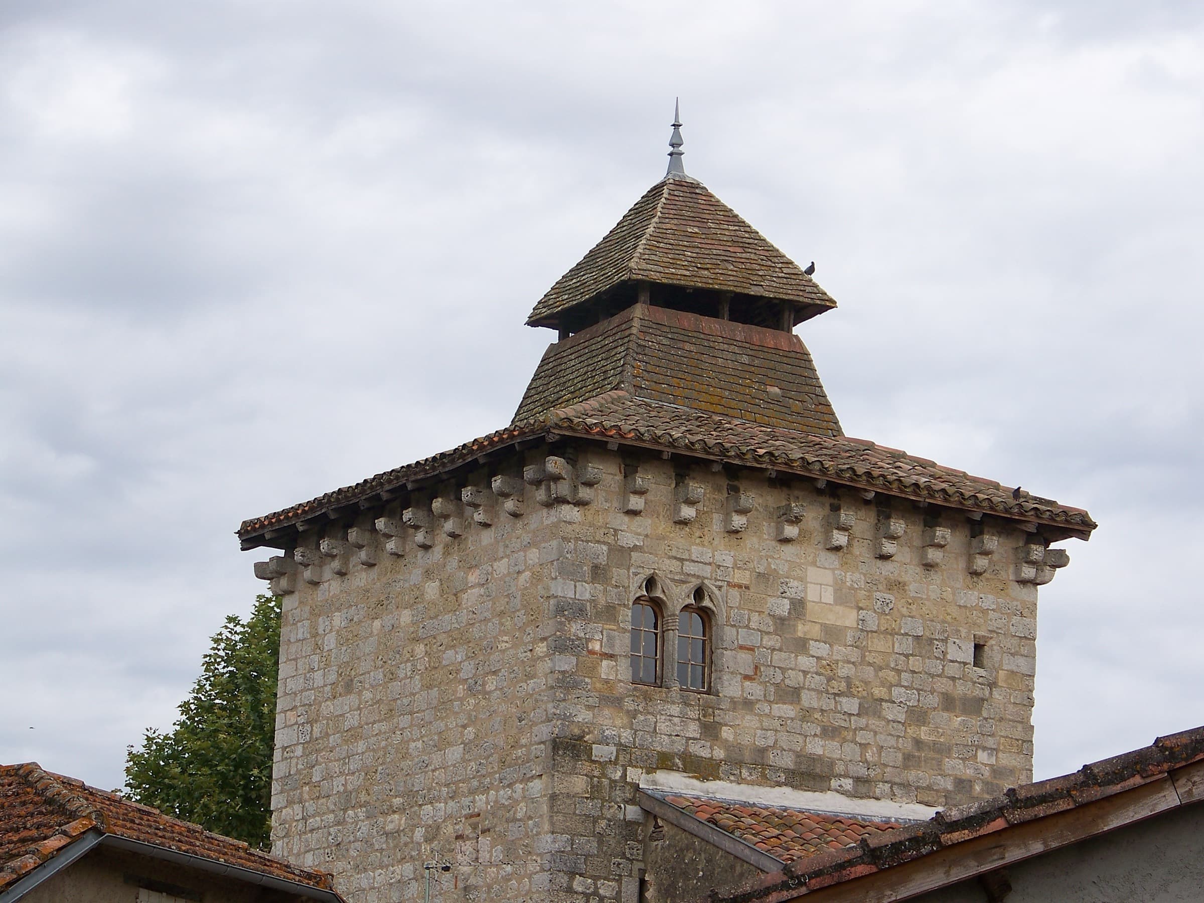 The square stone gate tower at Sarrant with its pyramidal tiled roof and small timber bell turret