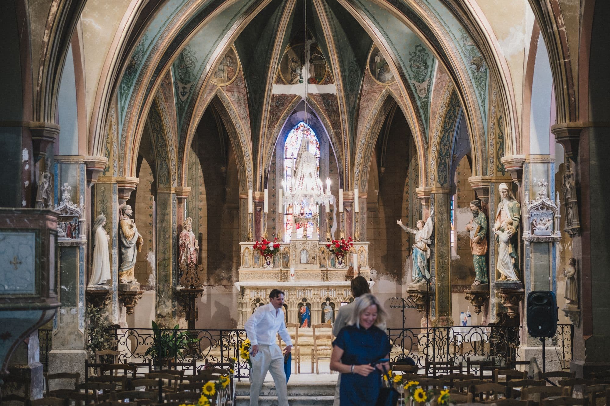 The painted vaulted interior of the church, dressed with sunflowers